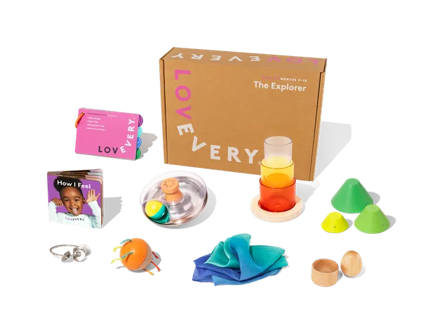 Lovevery Explorer Play Kit contents laid out showing wooden toys and play guide