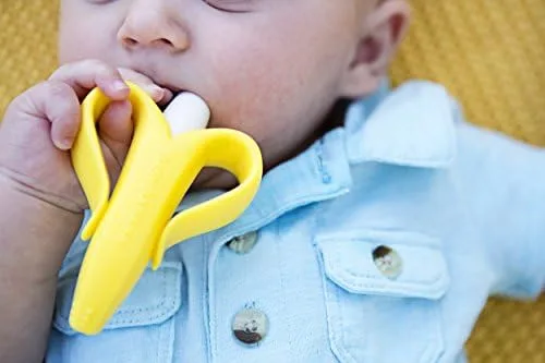 An infant mouths the silicone brush, demonstrating the teether-first design that introduces brushing