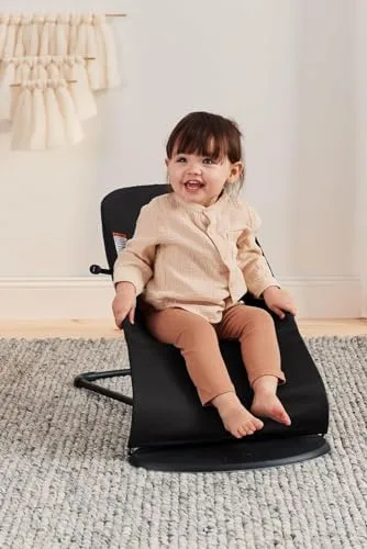 A toddler within the 20-pound weight limit sits upright in the highest recline setting.