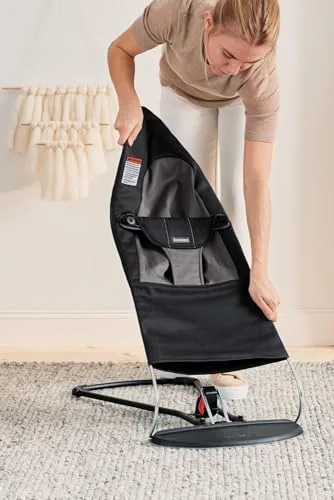 The fabric seat detaches from the steel frame for machine washing.
