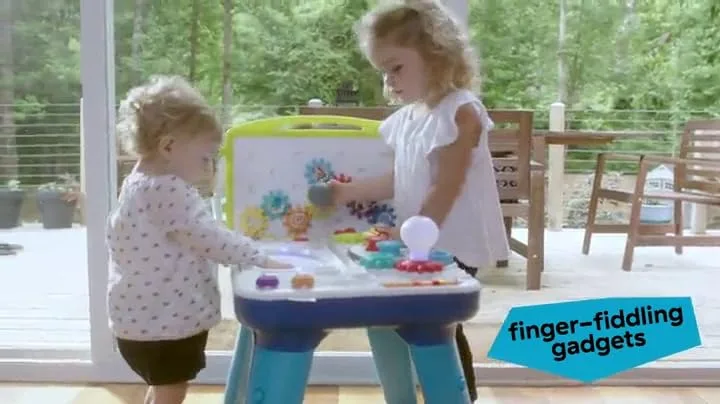 Two toddlers exploring the gears together on a sunlit deck, table mode in actual home use.