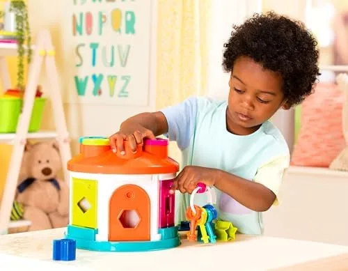 A toddler works the rooftop sorting holes during structured play in our home testing.