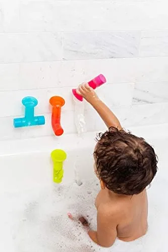 Modular pipe segments stick directly to bathroom tile, forming a configurable water-flow circuit.