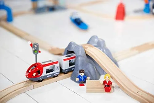 The included passenger train, signal, and figures arranged on a starter loop with rock tunnel.