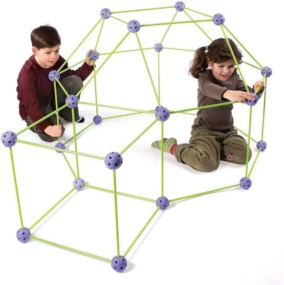 Two children collaborate on a geodesic dome, working from opposite sides to extend its frame.