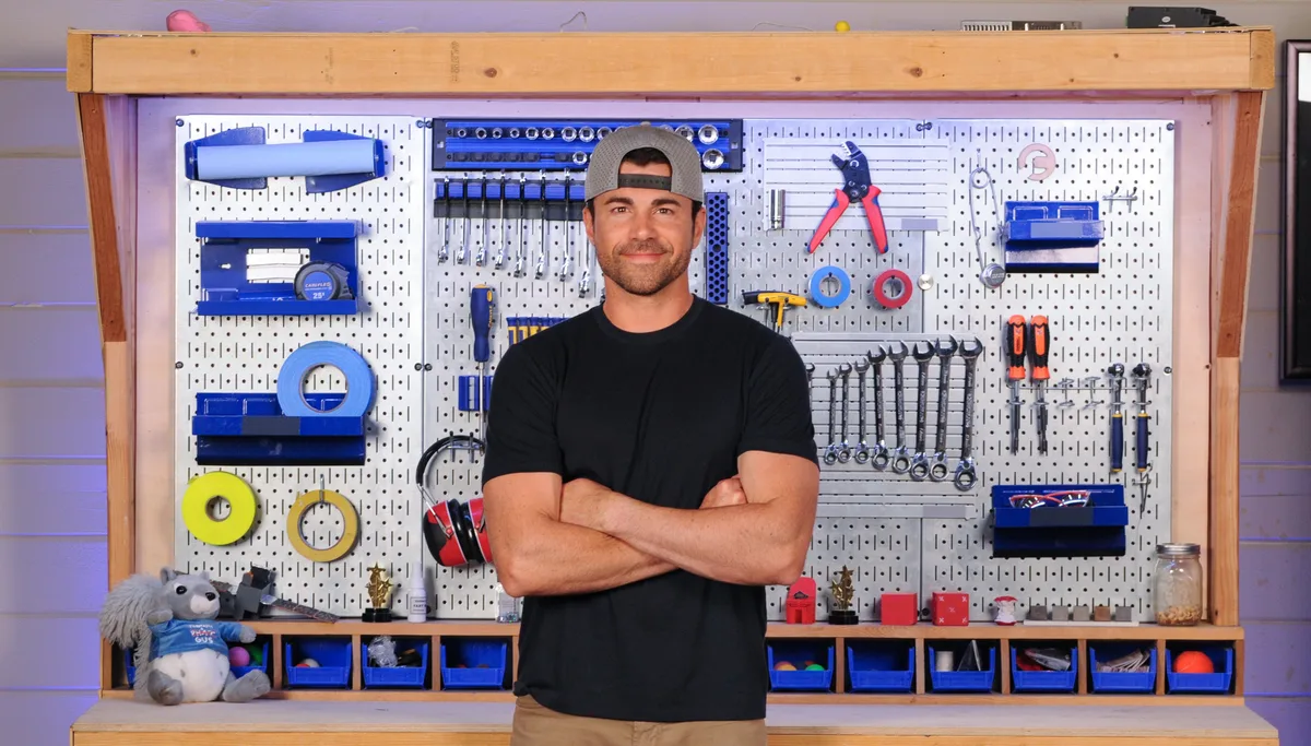 Mark Rober at his CrunchLabs pegboard, the workshop aesthetic the brand sells to families.