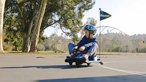 A helmeted child mid-drift on flat pavement, the vehicle pivoting around its rear casters.