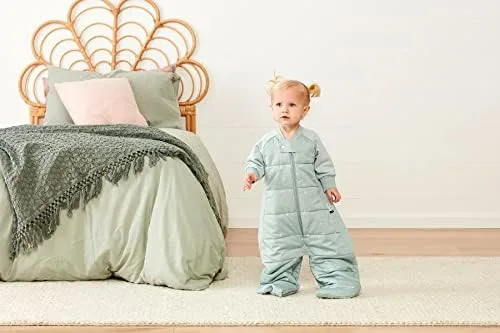 A toddler in the sleep suit configuration with legs out, demonstrating the freedom of movement that 