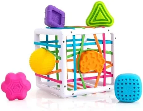 Six textured shapes surround the cube — each invites a different grip and pushing strategy.