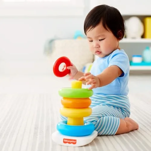 Grasping, releasing, aiming the ring onto the post: each attempt rehearses fine motor coordination.