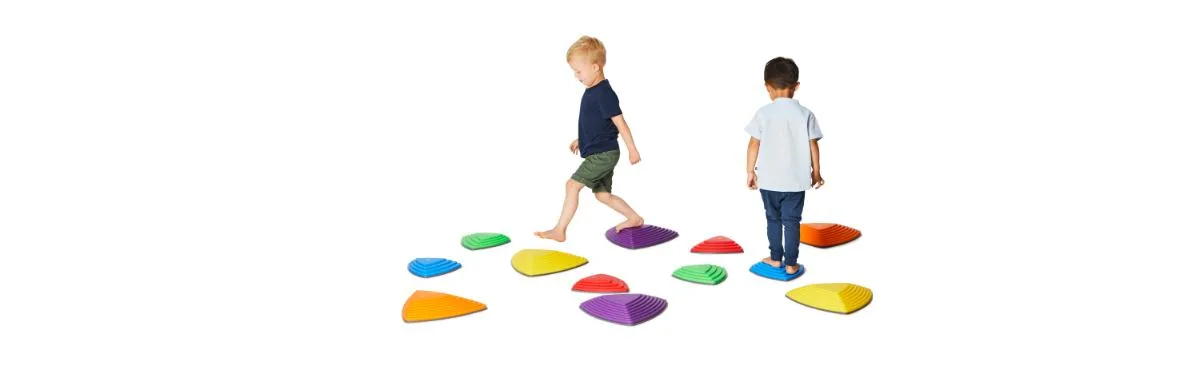 Two children navigate the full set of eleven Riverstones, each scaled and angled differently.