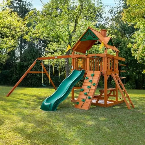 Assembled and installed: cedar timbers, green wave slide, and dual swings staged on level lawn.