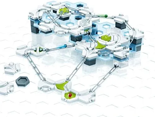 A built track threads a marble across magnetic cannons, hexagonal tiles, and gravity-fed slopes.