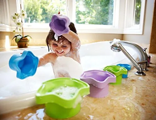 In the bath, the cups become scoops, sieves, and pour-toys, multiplying their use beyond stacking.