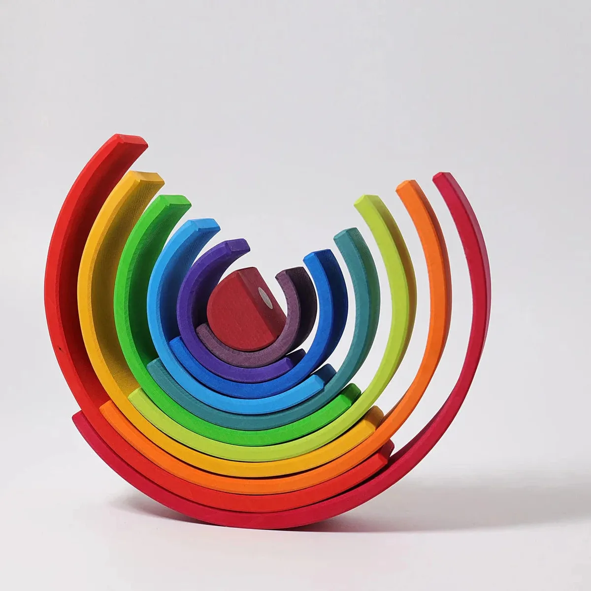 In open-ended play the rainbow becomes backdrop, fortress, and stage in the same afternoon.