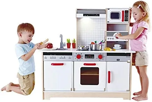 Two children engage in collaborative pretend cooking at the Hape All-in-1 Kitchen.