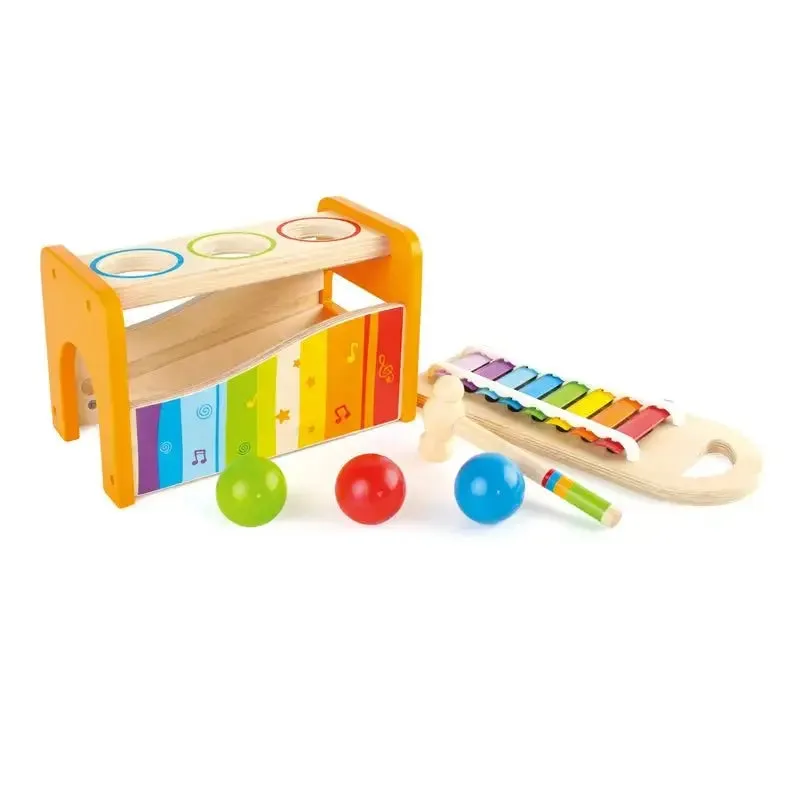 Three balls, a wooden mallet, and a removable xylophone — the full system that lives inside the benc
