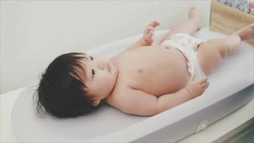 An older infant rests on the pad, illustrating the upper end of its useful weight range.