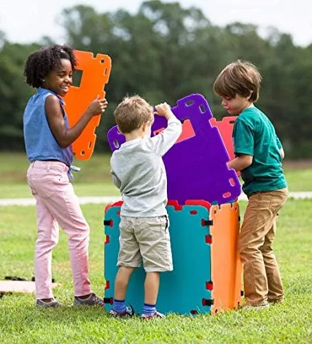 Outdoor assembly demonstrates the kit handles grass, sun, and group construction equally well.