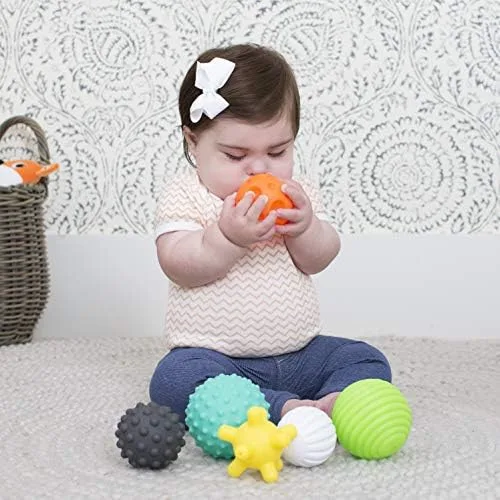 Oral exploration of the smooth orange ball, with the remaining textures arrayed nearby.