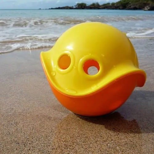 The Bilibo on a beach, where its smooth shell handles sand, surf, and rough use.