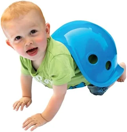 A toddler crawls with the Bilibo as a turtle shell, an unscripted use Moluk anticipated.