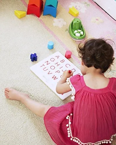 A toddler engages with the Magnatab independently, the screenless format inviting unhurried explorat