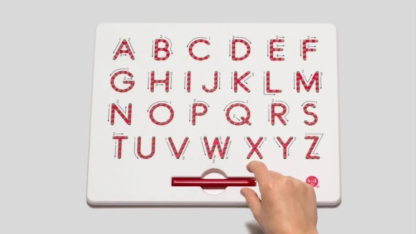 A child's hand activates the erase bar to reset the board, ready for the next letter.