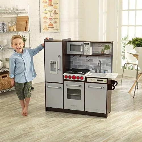 A child stands beside the kitchen, conveying its near-real scale against an adult-height countertop.