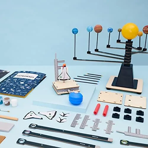 A typical crate unboxed: wooden parts, paints, fasteners, and laser-cut components laid out before a