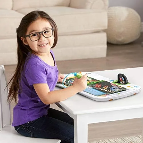 A preschooler taps the stylus to a page, the core interaction the system is built around.