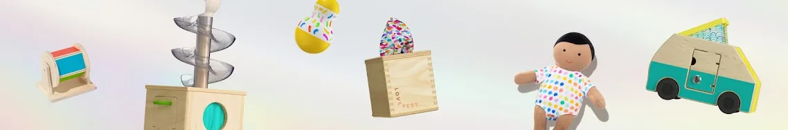 The Explorer kit's signature objects: ball runs, xylophone, dolls, and the wooden play truck.
