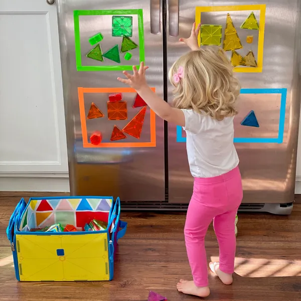 Child building with Magna-Tiles