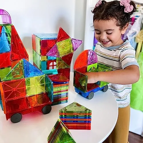 A wheeled car rolls toward a tile city — narrative play emerges once vehicles enter the build.