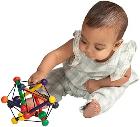 A baby grips the lightweight rattle, exploring its sliding wooden beads.