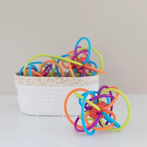 The Winkel sized against a household basket; at roughly four inches across, it fits a baby's full gr