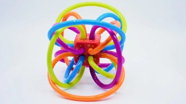 A close view of the central rattle cube, suspended inside the loop structure so it sounds with even 