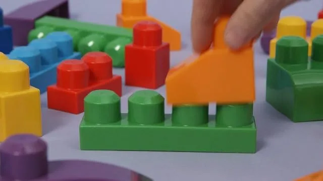 Studs connect with the gentle force a one-year-old can manage.