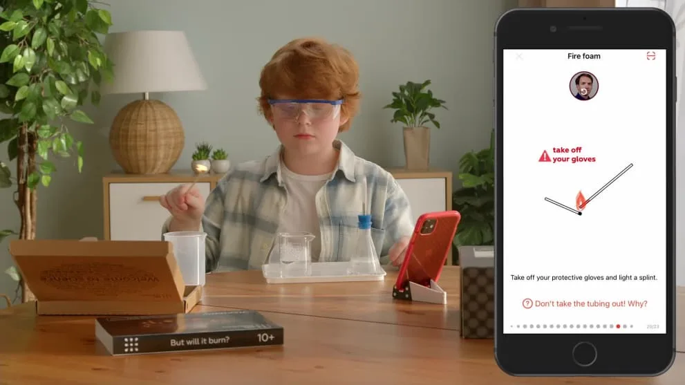 A young chemist follows the companion app's safety prompt before lighting the splint.