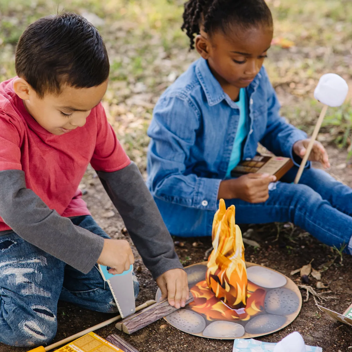 Children improvise camping scenarios, the kind of open-ended play this set is designed to seed.