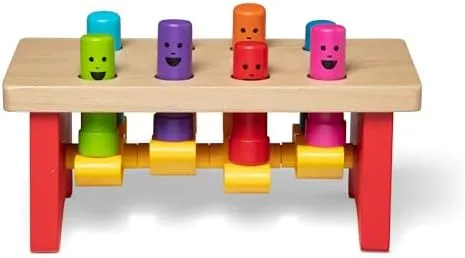 Four pegs on top, four already pounded through to the underside, ready to be flipped.