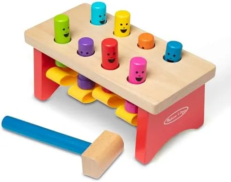The bench's eight peg layout and oversized blue mallet show the sturdy beech-wood construction.