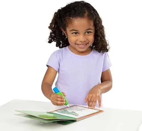 A toddler reveals colored artwork on a Water Wow! pad using only the water-filled pen.
