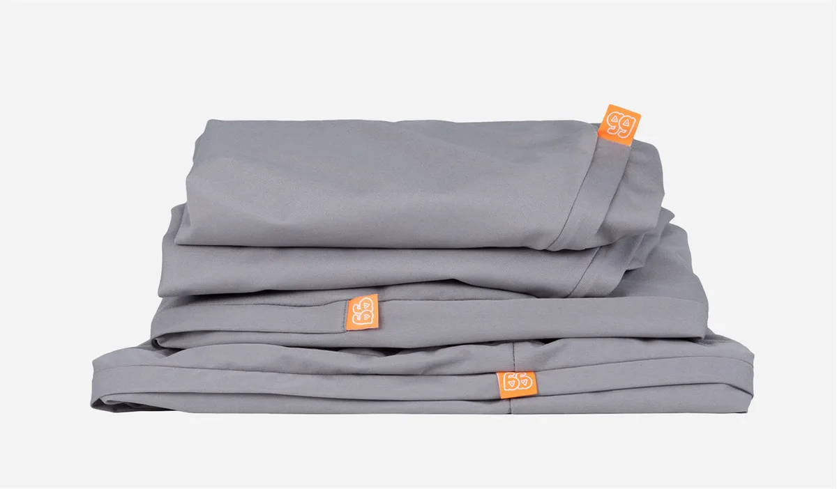 Stacked covers reveal the layered construction — two large base pieces and two triangular pillows, e