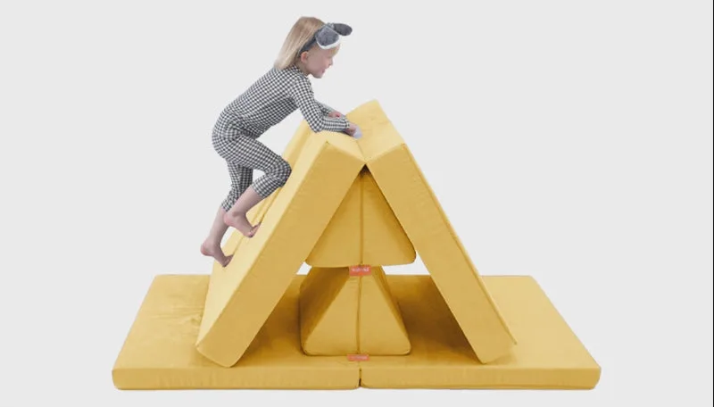 A child climbs the Mini in tent configuration — gross-motor play in a smaller footprint.