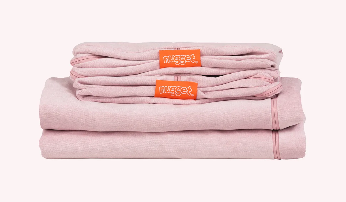 Replacement covers folded — Nugget's washable-cover ecosystem, sold separately, factors heavily into