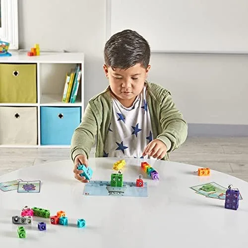 A child arranges the cubes into Numberblocks characters, mapping abstract value onto a physical, cou