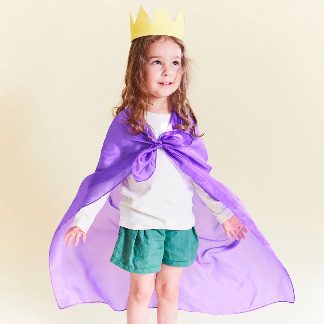 A purple silk knotted at the shoulders becomes a regal cape, transforming with the wearer's imaginat