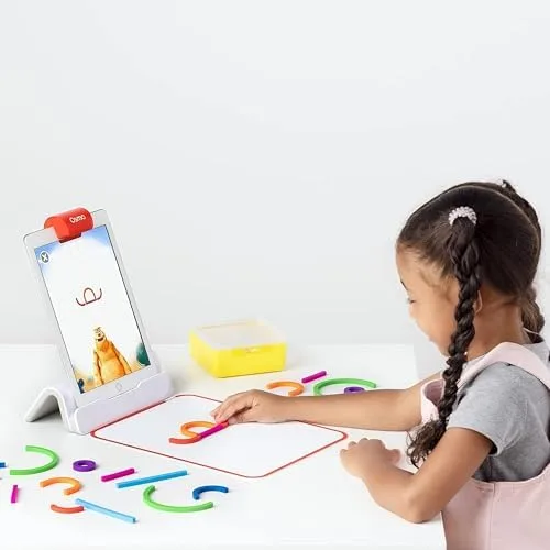 A preschooler arranges silicone shapes on the play mat while the iPad tracks each piece in real time