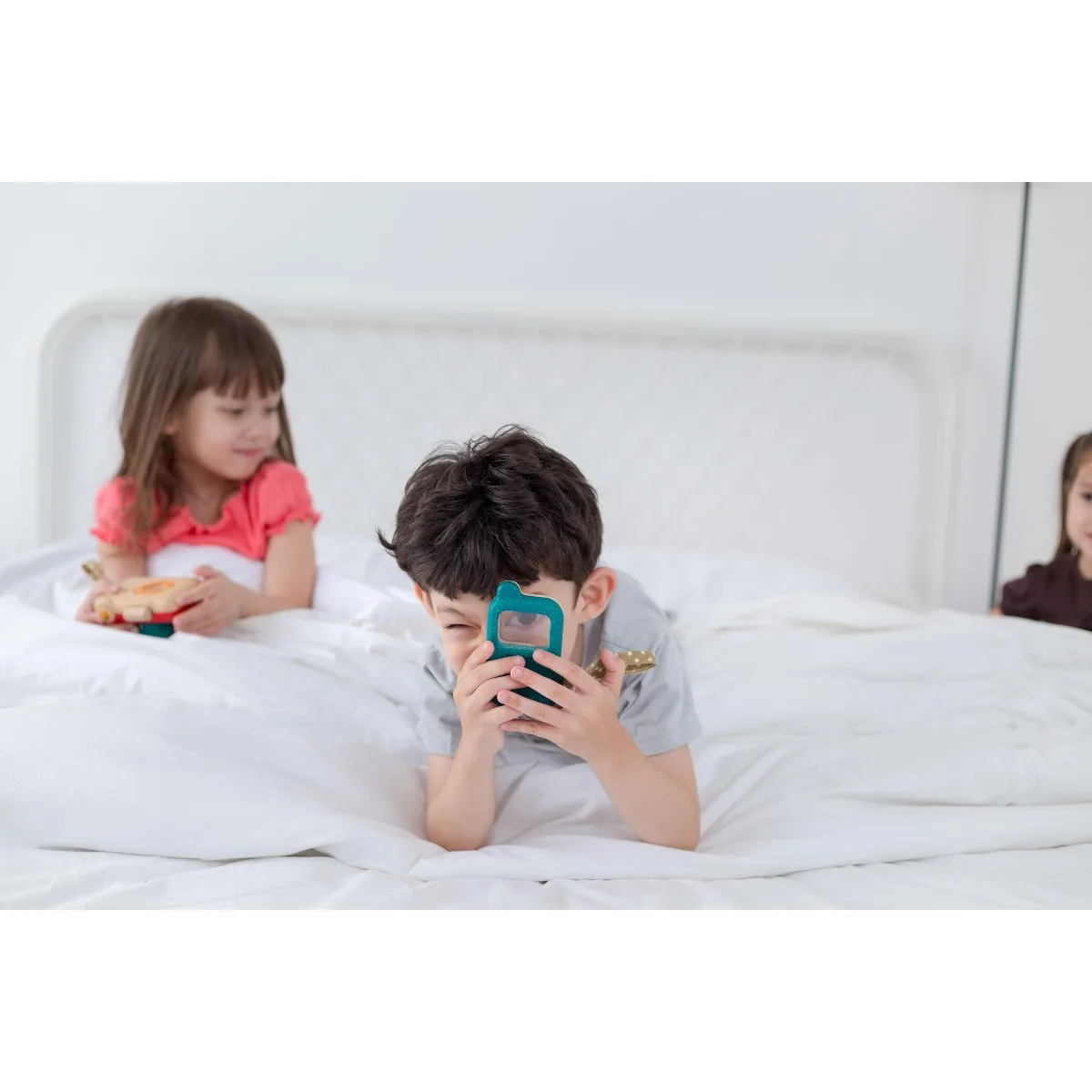Pretend phone calls in action: imaginative play that mirrors adults without screens or batteries.